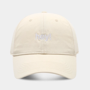 Close-up of hey! purple embroidery on cream cotton baseball cap with stitched details
