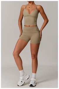 Close-up of women's two-piece yoga set with deep V-neck sports bra and high-waisted shorts