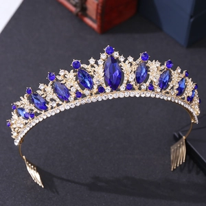 Detail of a bridal crown with blue gemstones and diamonds on a gold metal frame