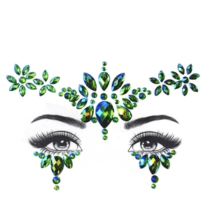Detailed teal green face jewels and glitter rhinestones for forehead and eye makeup