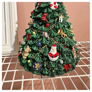 Close-up of a festive Christmas tree music box featuring Santa Claus and colorful ornaments