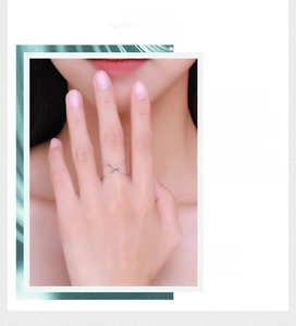 Close-up of a S925 sterling silver minimalist ring with a cross-geometric X design