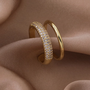 Macro shot of double-layer gold-plated ring with micro-pave zircons on champagne satin