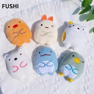 Set of six cute plush cartoon charms with embroidery on a white knitted background