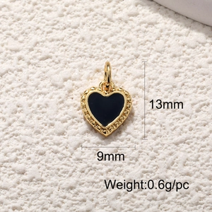 Detail view of a 13x9mm gold heart pendant with black enamel and beaded edge