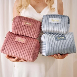 Large capacity velvet cosmetic bags in pink and blue with personalized gold name labels