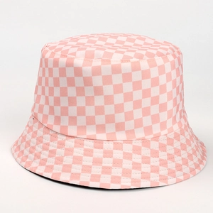 Detailed close-up of pink and white checkerboard pattern on the reversible bucket hat