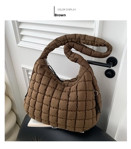 Close-up of brown quilted cloud bag featuring soft padded nylon texture and square pattern