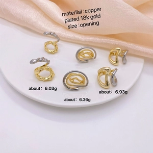 18k gold plated copper geometric rings in various spiral designs on white tray