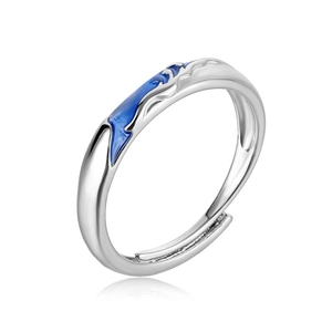 Detailed view of silver fishtail ring featuring blue enamel wave texture and open band