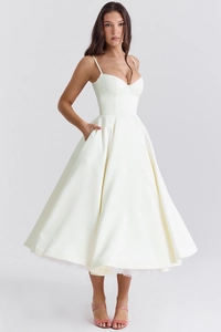 Detail of elegant ivory satin A-line gown showing heart-shaped neckline and side pockets
