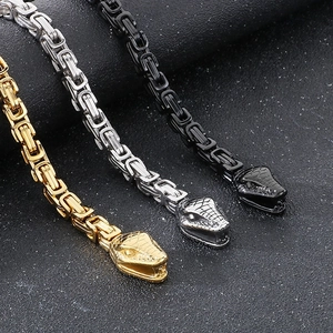 Detail of Byzantine men's necklaces with double snake heads in gold, silver, and black finish