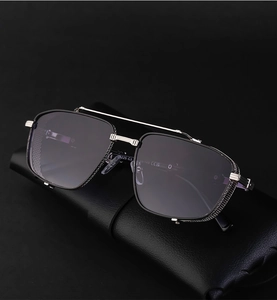Detail view of square metal frame sunglasses with mesh side shields on leather case