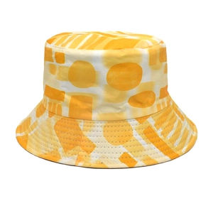 Close-up of vibrant yellow and orange geometric print on cotton bucket sun hat