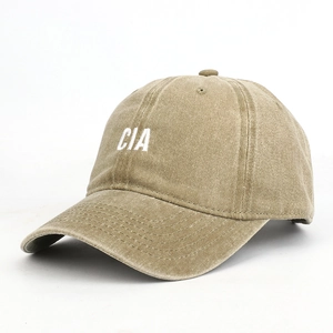 Close-up of CIA letter embroidery and washed khaki cotton texture on baseball cap