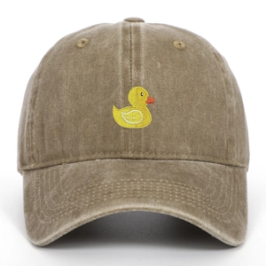 Close-up of yellow duck embroidery on brown washed cotton baseball cap with curved brim