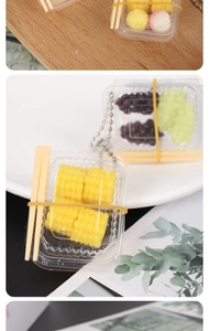 Miniature dollhouse food charms with fake corn and grapes in small plastic boxes
