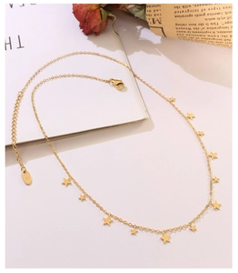 Close-up of golden choker with star pendants and K18 hallmark detail on 18k plated metal