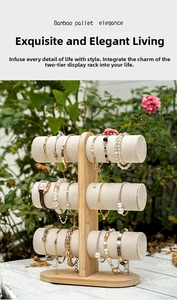 Three-tier bamboo jewelry stand with velvet bars displaying bracelets and watches