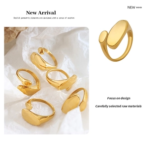 Detailed view of minimalist gold geometric open ring with irregular oval and dot design