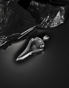 Macro shot of silver crow skull pendant showing S.STEEL hallmark on the stainless steel bail