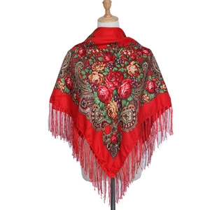 Close-up of ethnic red floral shawl with rose paisley prints and long fringe tassels