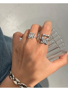 Detailed view of women wearing two 925 sterling silver rings with clear zircon stones
