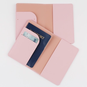 Pink PU leather passport holder with slots for cards shown in open and used states