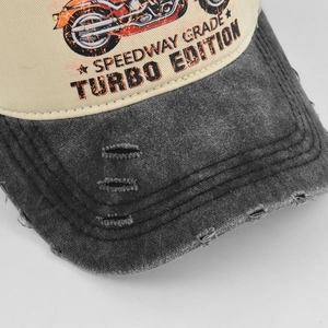 Detailed close-up of grey distressed brim and beige panel with Speedway Grade embroidery