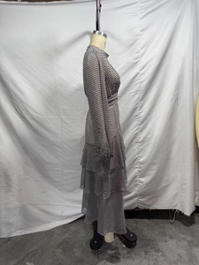 Detailed side view showing tiered layered skirt and polka dot chiffon fabric of the dress
