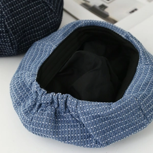 Light blue woven octagonal newsboy hat with elastic band and soft inner lining