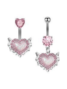 Macro view of silver belly rings featuring pink zircon hearts and winged heart charms