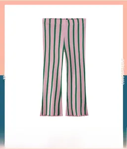 Detailed view of pink and dark green vertical striped ribbed flared pants for girls
