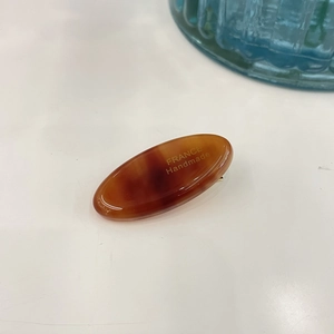 Handmade amber resin hair clip with tortoiseshell pattern and rhinestone bow detail