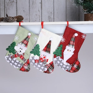 Linen Christmas stockings with 3D Santa, Snowman, and Bear hung on a white mantel