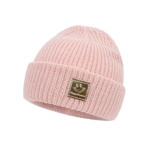 Pink knitted beanie for babies featuring a golden smiley face patch and ribbed texture