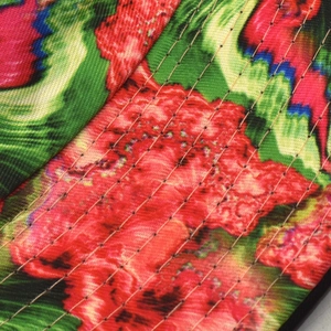 Close-up of vibrant floral print and detailed parallel quilting on the reversible bucket hat