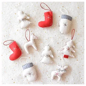 Flat lay of 9-piece handmade felt Christmas ornaments with embroidery and stitching