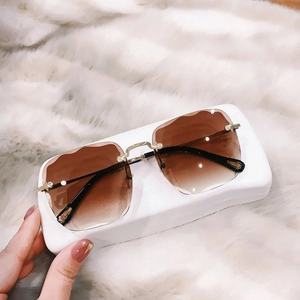 Frameless square sunglasses for women with brown gradient lenses and gold rhinestone trim