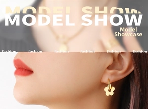 Detail of gold floral pendant earrings showing the intricate five-petal flower design