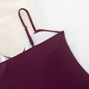 Detail of burgundy bodysuit with thin adjustable straps and soft inner chest pads