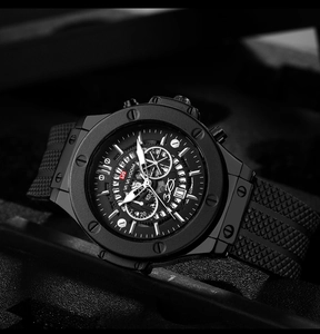Detailed close-up of a black sporty men's watch featuring a textured silicone strap and dial
