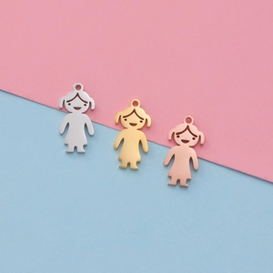 Detailed view of polished metal girl-shaped pendants in silver, gold, and rose gold finish