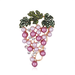 Detail of grape bunch brooch with purple pearls and green rhinestone leaves in gold setting