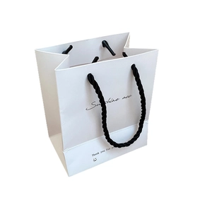 Minimalist white paper jewelry gift bag with black rope handles and Sunshine acc text