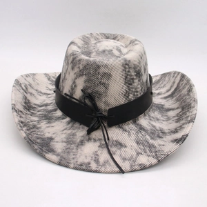 Detail of western cowboy straw hat featuring marble texture and black leather band