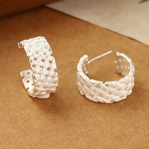 Braided texture C-shaped silver earrings with a woven metal design and polished finish