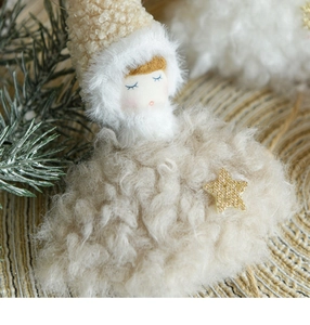Close-up of plush Christmas angel ornament with golden star and sherpa wool texture