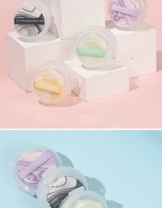 Close-up of marble pattern finger powder puffs in a round storage box with colorful ribbons