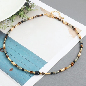 Ethnic handmade beaded necklace with natural stones, shells, and a black faceted center stone